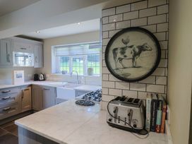 A kitchen with a gas stove and sink at Westhaven in Lyme Regis