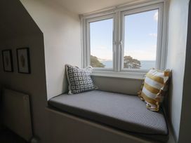 A snug area with a window seat and pillows at Westhaven in Lyme Regis