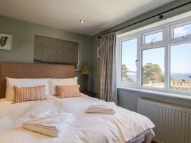 A bedroom with a double bed and a window at Westhaven in Lyme Regis