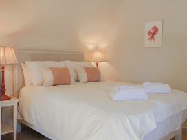 A bedroom with a bed and lamps at Westhaven in Lyme Regis
