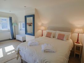A bedroom with a bed and lamps at Westhaven in Lyme Regis