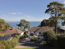 A view of houses and trees with the sea in the background at Westhaven Lyme Regis