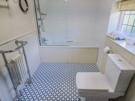 A bathroom with a bathtub and toilet at Westhaven in Lyme Regis