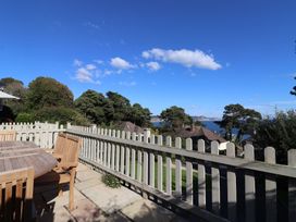An outdoor space with a table and chairs at Westhaven in Lyme Regis