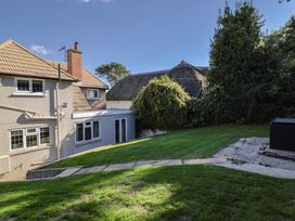 A garden with grass and trees at Westhaven in Lyme Regis