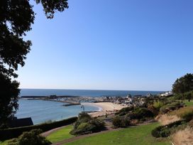 View of a beach and sea with houses at Westhaven in Lyme Regis