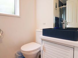 A bathroom with a toilet and sink at High Bullen Lodge, Morcombelake