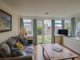 A living room with a sofa and coffee table at Penny Plot Cottage in Lyme Regis
