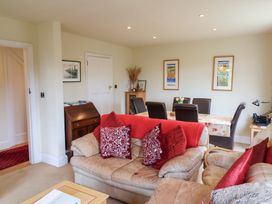 A living room with a sofa and dining table at Barn Close Farm in Morcombelake