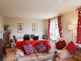A living room with sofa and dining table at Barn Close Farm Morcombelake