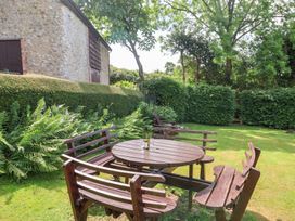 A garden with a table and chairs at Barn Close Farm Morcombelake