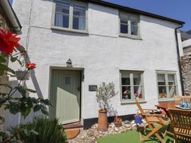 An exterior view of Cleve Cottage with door and garden in Lyme Regis
