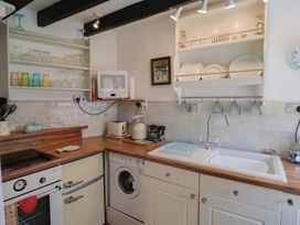 A kitchen with appliances and dishes at Cleve Cottage in Lyme Regis