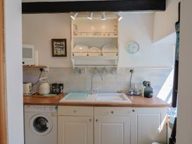 A kitchen with a sink and appliances at Cleve Cottage in Lyme Regis