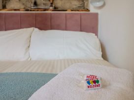 A bed with pillows and a towel in the bedroom at Cleve Cottage in Lyme Regis