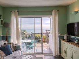 A living room with a view of the sea at 1 Wellhayes Lyme Regis