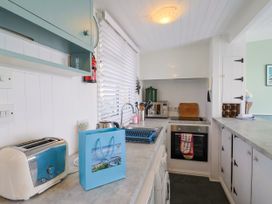 A kitchen with a sink and appliances at 1 Wellhayes Lyme Regis