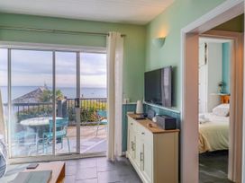 A living room with a sliding door and view at 1 Wellhayes in Lyme Regis