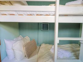 A bunk bed with pillows and a towel at 1 Wellhayes in Lyme Regis