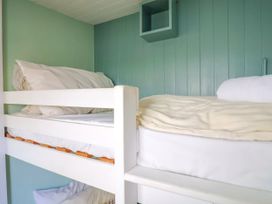 A bedroom with a bunk bed and shelf at 1 Wellhayes, Lyme Regis