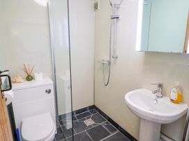 A bathroom with a shower, toilet, and sink at 1 Wellhayes in Lyme Regis
