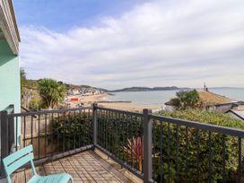 A balcony view of the sea and beach at 1 Wellhayes in Lyme Regis