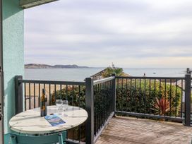 A balcony with a table and drinks overlooking the sea at 1 Wellhayes Lyme Regis