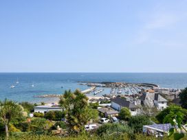 A view of a harbor with boats and buildings at 1 Wellhayes in Lyme Regis
