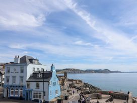 A coastal view with a blue building at 1 Wellhayes in Lyme Regis