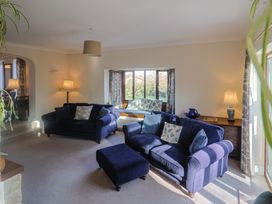 A living room with sofas and a coffee table at High Cliff Orchard in Lyme Regis