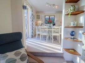 A dining room with a table and chairs at High Cliff Orchard in Lyme Regis