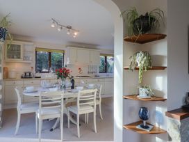 A kitchen with a table and chairs at High Cliff Orchard in Lyme Regis
