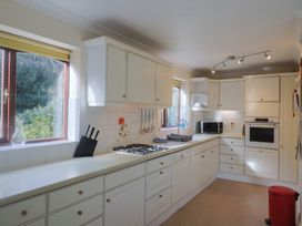 A kitchen with a gas stove and microwave at High Cliff Orchard in Lyme Regis