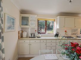 A kitchen with a table and chairs at High Cliff Orchard in Lyme Regis