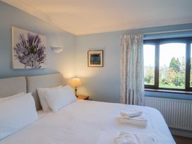 A bedroom with a bed and lamp at High Cliff Orchard in Lyme Regis