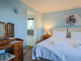 A bedroom with a bed and dressing table at High Cliff Orchard in Lyme Regis