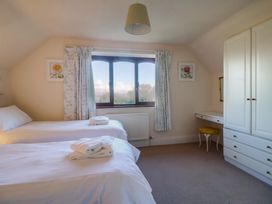 A bedroom with two beds and a window at High Cliff Orchard in Lyme Regis