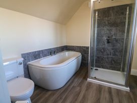 A bathroom with bathtub, toilet and shower at High Cliff Orchard in Lyme Regis