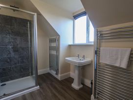 A bathroom with a shower and sink at High Cliff Orchard in Lyme Regis