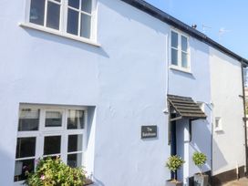 The exterior of The Bakehouse with a sign and plants at Lyme Regis