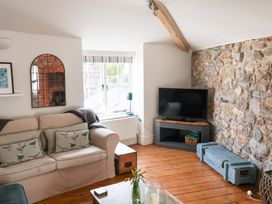 A living room with a sofa and television at The Bakehouse in Lyme Regis