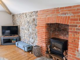 A living room with a television and fireplace at The Bakehouse in Lyme Regis