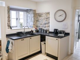 A kitchen with cabinets, sink, and appliances at The Bakehouse in Lyme Regis