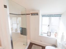 A bathroom with a shower and toilet at The Bakehouse in Lyme Regis