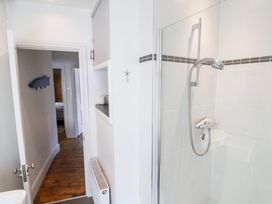 A shower enclosure with a showerhead in a bathroom at The Bakehouse in Lyme Regis