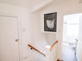 A staircase leading to a bathroom with a painting in the hallway at The Bakehouse Lyme Regis
