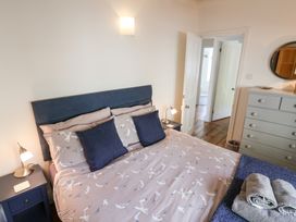 A bedroom with a bed and bedside lamps at The Bakehouse in Lyme Regis