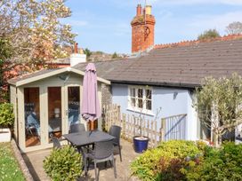 A garden with outdoor furniture and a shed at The Bakehouse in Lyme Regis