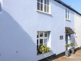 A blue exterior wall with a window and sign at The Bakehouse in Lyme Regis