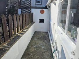 An outdoor area with a fence and window at Foxley Cottage in Charmouth